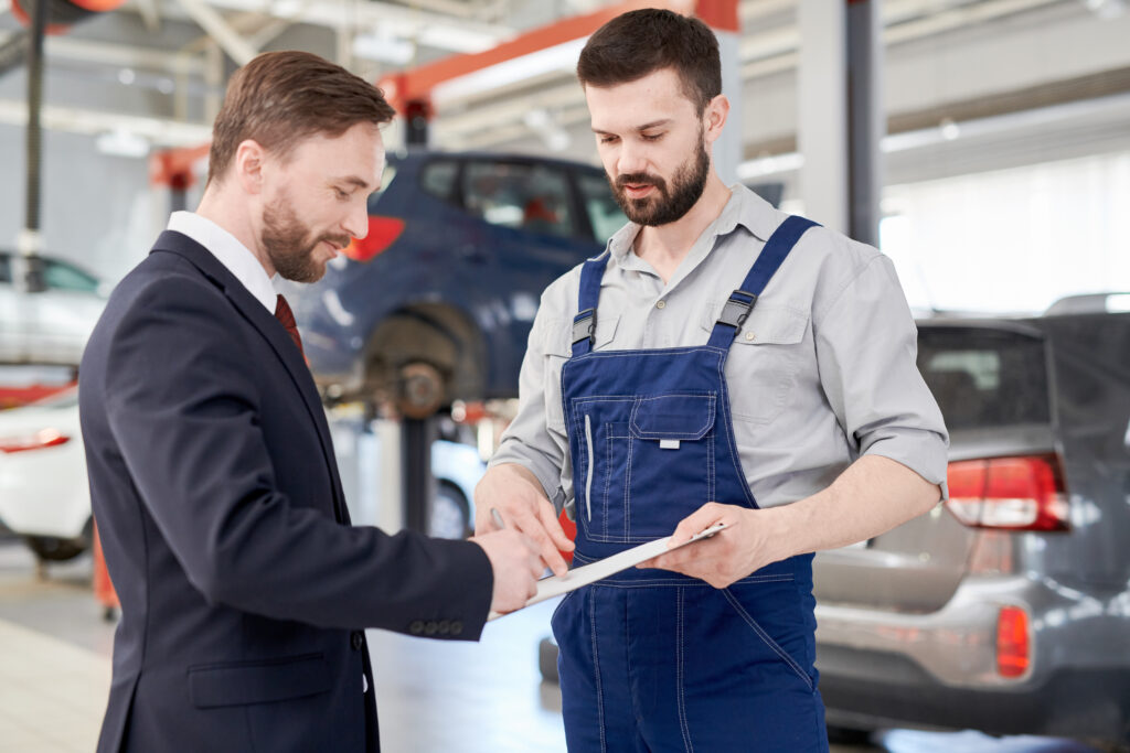 Customer signing the paper to approve the financial service spent on vehicle