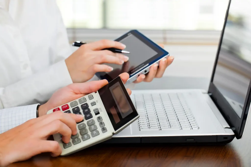 Validating payroll solutions with Calculator and laptop